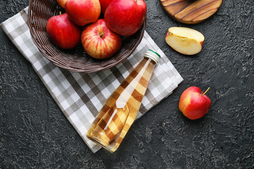 Bottle of apple cider vinegar on dark background