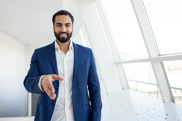 office worker in a suit gets a job, holds out his hand and smiles, hiring employees, interviewing bosses