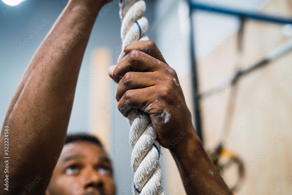 Poster Athletic man doing climbing exercise.