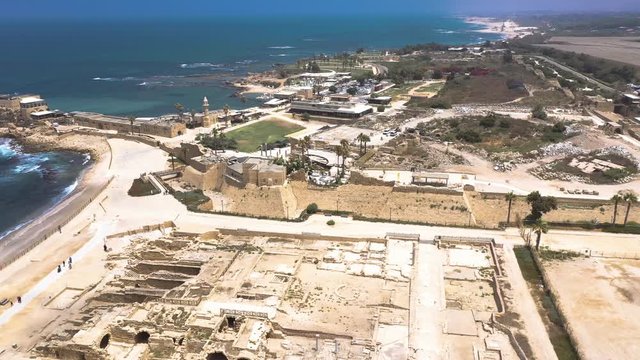 Aerial panorama view of Casarea Maritima, ancient walled city from the Roman, Byzantine and Crusader era with city walls, bastions on the coast of the Mediterranean sea in Israel