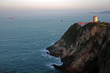 Fototapeta na wymiar Lighthouse on a cliff at Cape D'aguilar, or Hok Tsui, on the southeastern tip of Hong Kong Island
