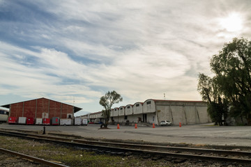 Fototapeta na wymiar Pantaco. Ciudad de Mexico. Mexico 11/01/2020. train tracks in the middle of warehouses made of bricks