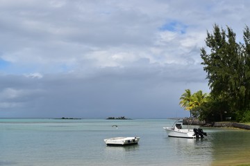 Beautiful view from a tropical beach, small islands on a calm waters in background