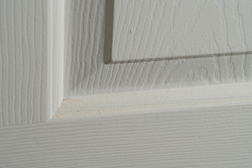 Close up of dust accumulation on the panels of an interior door.