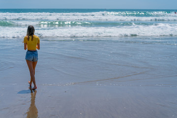 Teenage girl standing on beach