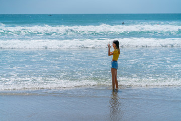 Teenage girl standing on beach