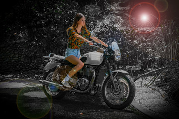 Fototapeta na wymiar Young woman in casual clothing on classic motorcycle