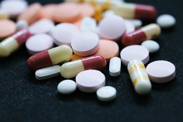 Pills on black background