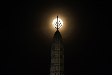 Magic night moment; full moon coincide with the top of The City Pillar Shrine of Bangkok is the...
