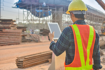 Foreman holding tablet use technology inspection control construction architecture site