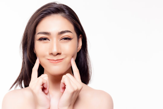 Asian woman get soft moist skin face by touching beauty face. Attractive beautiful young girl get happy, smiley face and satisfied her facial skin. Pretty woman has beautiful face. skin care concept.