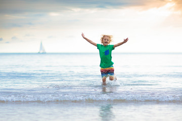 Kids play on tropical beach. Sand and water toy.