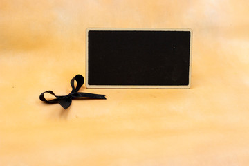 Black chalkboard with black ribbon