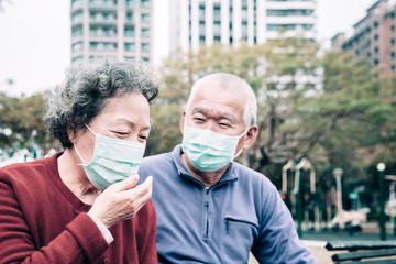 sick senior couple wear with protective face mask