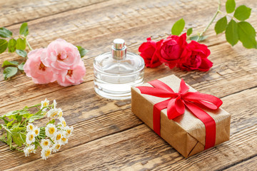 Gift box on wooden boards with rose flowers
