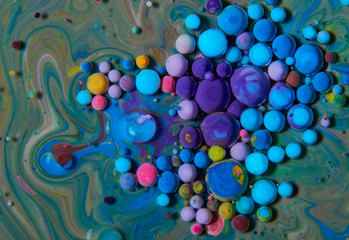 Obraz na płótnie Canvas Macro photography of colorful bubbles on some fluids that seems to be some kind of unknown worlds.