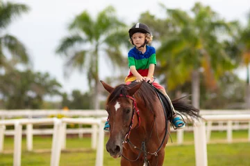 Foto op Canvas Kids ride horse. Child on pony. Horseback riding. © famveldman