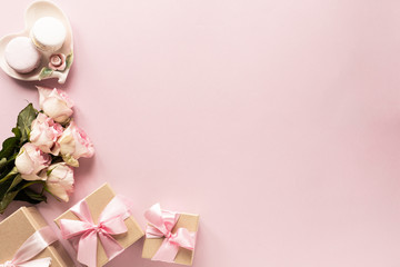 Gift box or gift box and flowers on pink table top view. Flat lay. Birthday, wedding, valentines day, march 8th concept. copy space