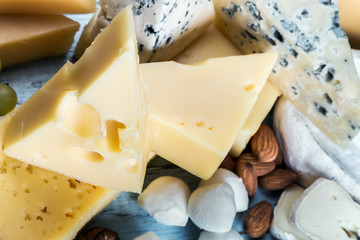 assortment of various cheeses with grapes, nuts. Cheese plate