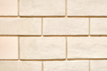 Background from a wall with beige stone slabs