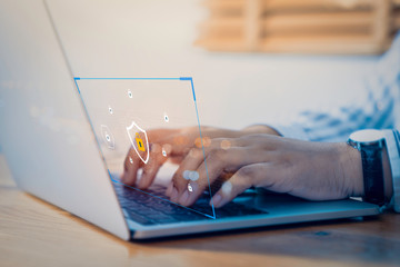 Businessman using a laptop computer with technology cybersecurity and privacy concept. protection and safe data for global network security.