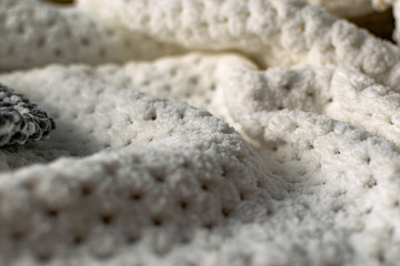 Fine textured and voluminous fabric in white and gray. Embossed textile pattern, pleasant to the touch and delicate, velvety and textured background for design and decoration.