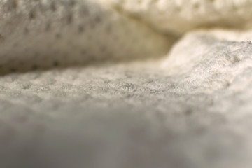 Fine textured and voluminous fabric in white and gray. Embossed textile pattern, pleasant to the touch and delicate, velvety and textured background for design and decoration.
