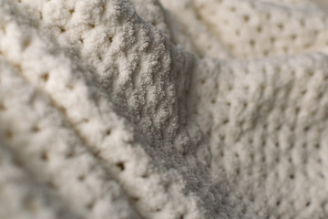 Fine textured and voluminous fabric in white and gray. Embossed textile pattern, pleasant to the touch and delicate, velvety and textured background for design and decoration.