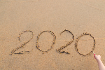 Abstract message Year 2020 written on beach sand