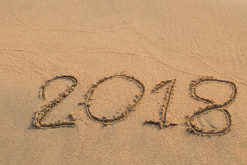 2018 message written in the sand at the beach