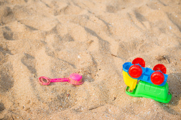 Fototapeta na wymiar Colourful Toy car on the sand beach
