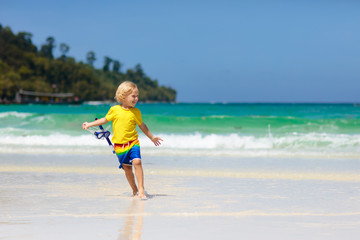 Fototapeta na wymiar Child snorkeling on tropical beach. Kids snorkel.