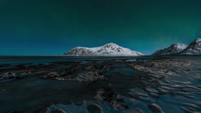 Timelapse of the Northern Lights above mountains in Lofoten Islands