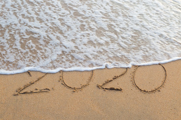 Abstract message Year 2020 written on beach sand