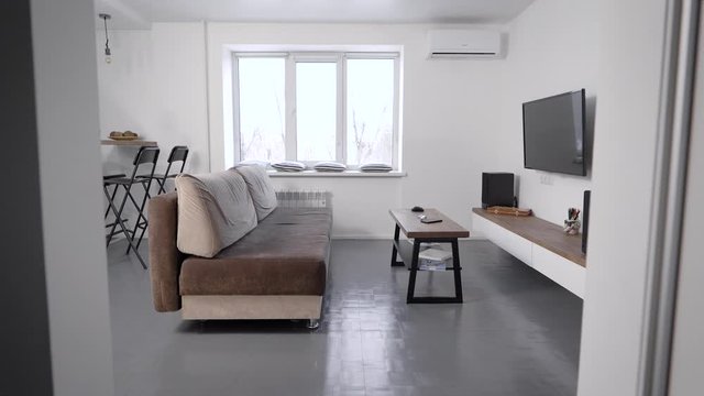 cozy living room with minimalistic scandinavian interior with grey and white colors
