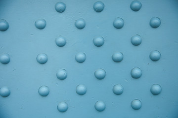 texture of blue metal construction with rivets close up