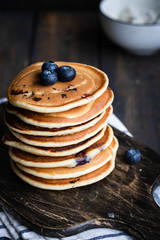 ricotta pancakes with blueberries on a dark wooden background