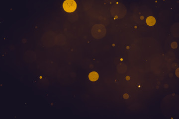 Dark Abstract Gold bokeh sparkle on black background