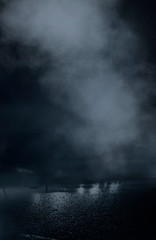 Wet asphalt, reflection of neon lights, a searchlight, smoke. Abstract light in a dark empty street with smoke, smog. Dark background scene of empty street, night view, night city.