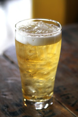beer in a glass isolated on wood table.