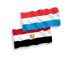 National vector fabric wave flags of Egypt and Luxembourg isolated on white background. 1 to 2 proportion.