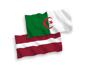 National vector fabric wave flags of Latvia and Algeria isolated on white background. 1 to 2 proportion.