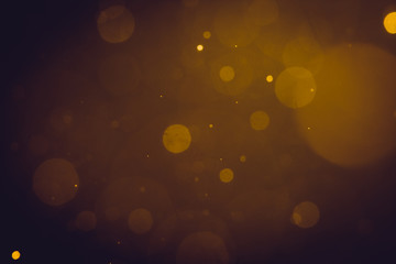 Dark Abstract Gold bokeh sparkle on black background