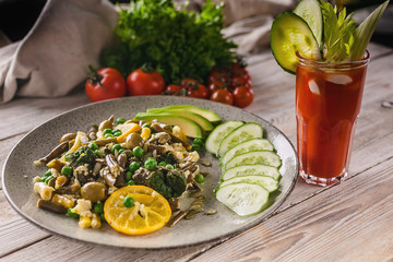 Vegetarian organic food. Beans and green peas salad, vegetables and herbs, tomato juice on a wooden background. Veggie nutrition
