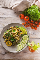 Vertical shot Vegetarian organic food. Beans and green peas salad, vegetables and herbs, tomato juice on a wooden background. Veggie nutrition. Top view