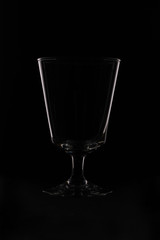 wine glass as idea and concept lighting and black background.