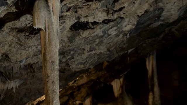 A Stalagnate or pillar or sinter column in a dark cave.
