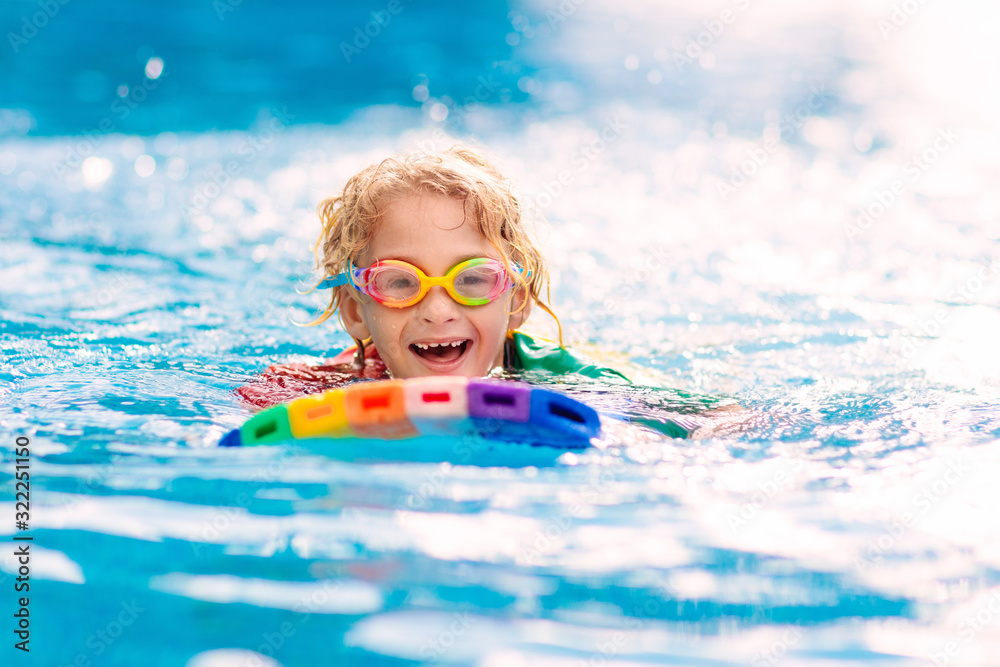 Wall mural Child learning to swim. Kids in swimming pool.