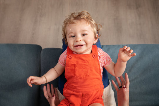 Smiling toddler lying on mother&acirc;&euro;&trade;s lap seen from above