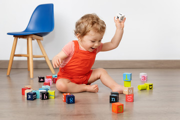 Happy baby building tower with blocks